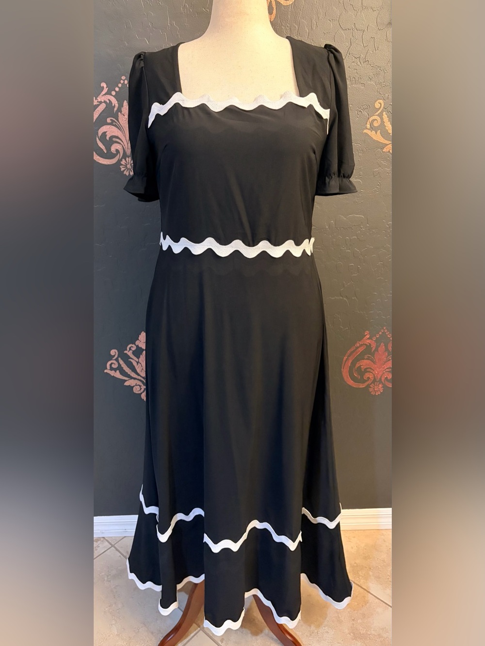 Elegant Black Dress with White Wave Trim